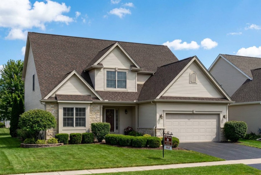 Calgary home with siding, stone trim, and a shingle roof